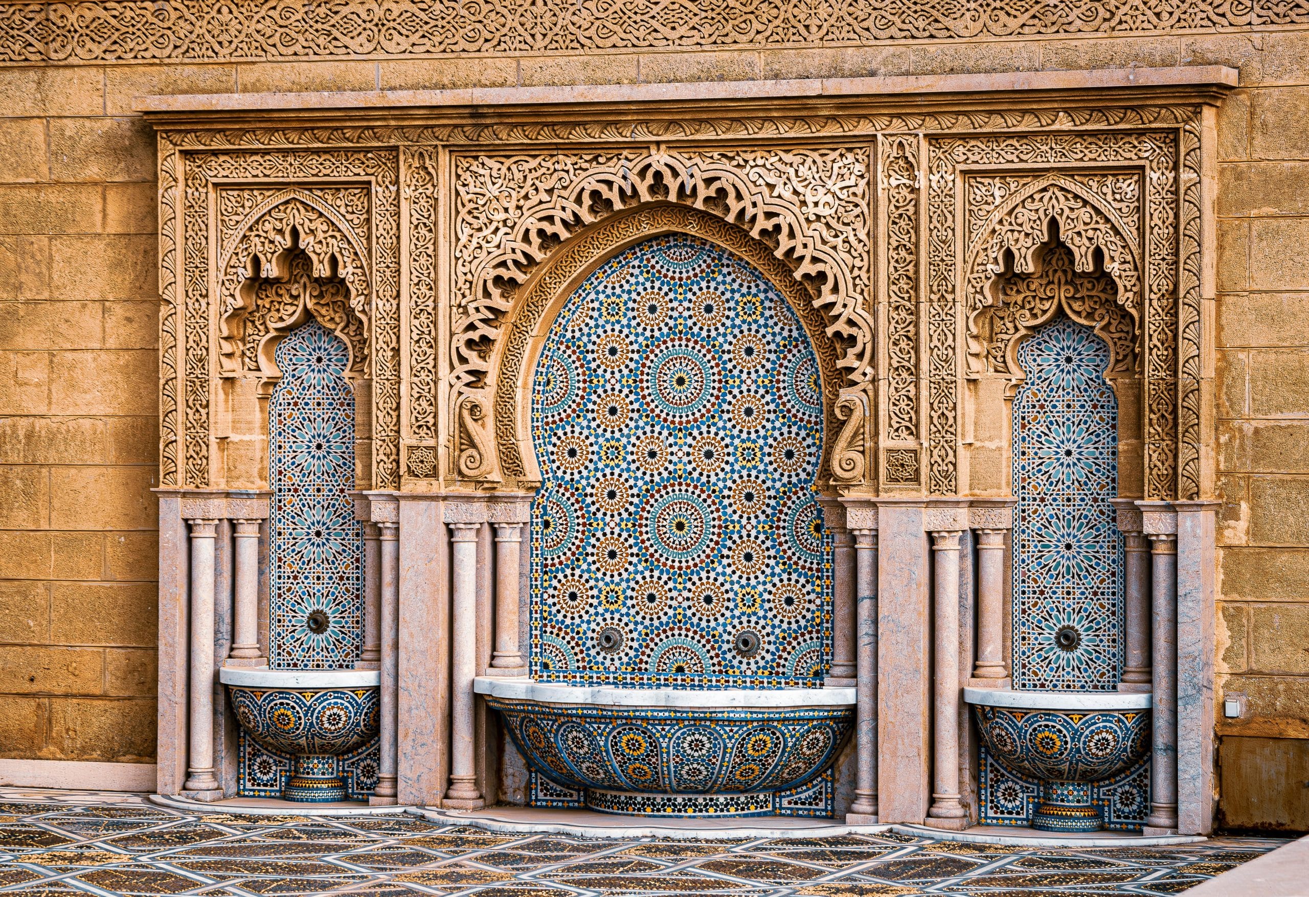 Beautiful Moroccan mosaic tile wall with fountains, showcasing intricate designs and cultural artistry.