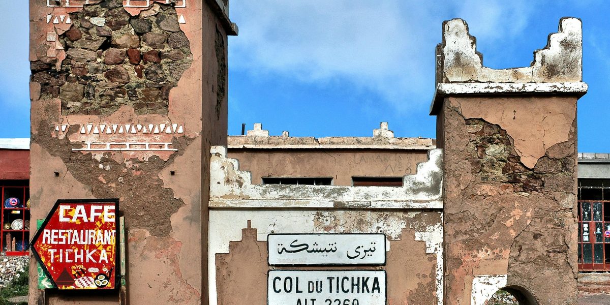 Historic Col du Tichka sign and structure on a sunny day in Morocco.
